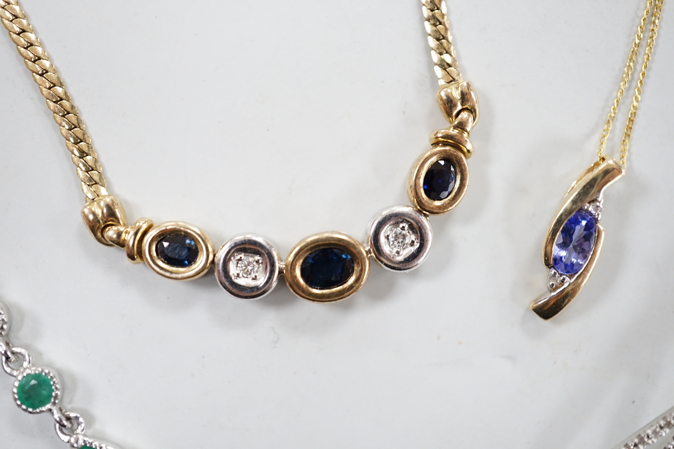Four assorted modern 375 and gem set pendant necklaces, including white 375 and diamond chip set, 50cm and white 375 and emerald drop set, gross weight 11.3 grams.